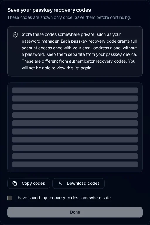 Save your passkey recovery codes dialog with ten concealed dedicated codes, download and copy actions, and a saved-confirmation checkbox